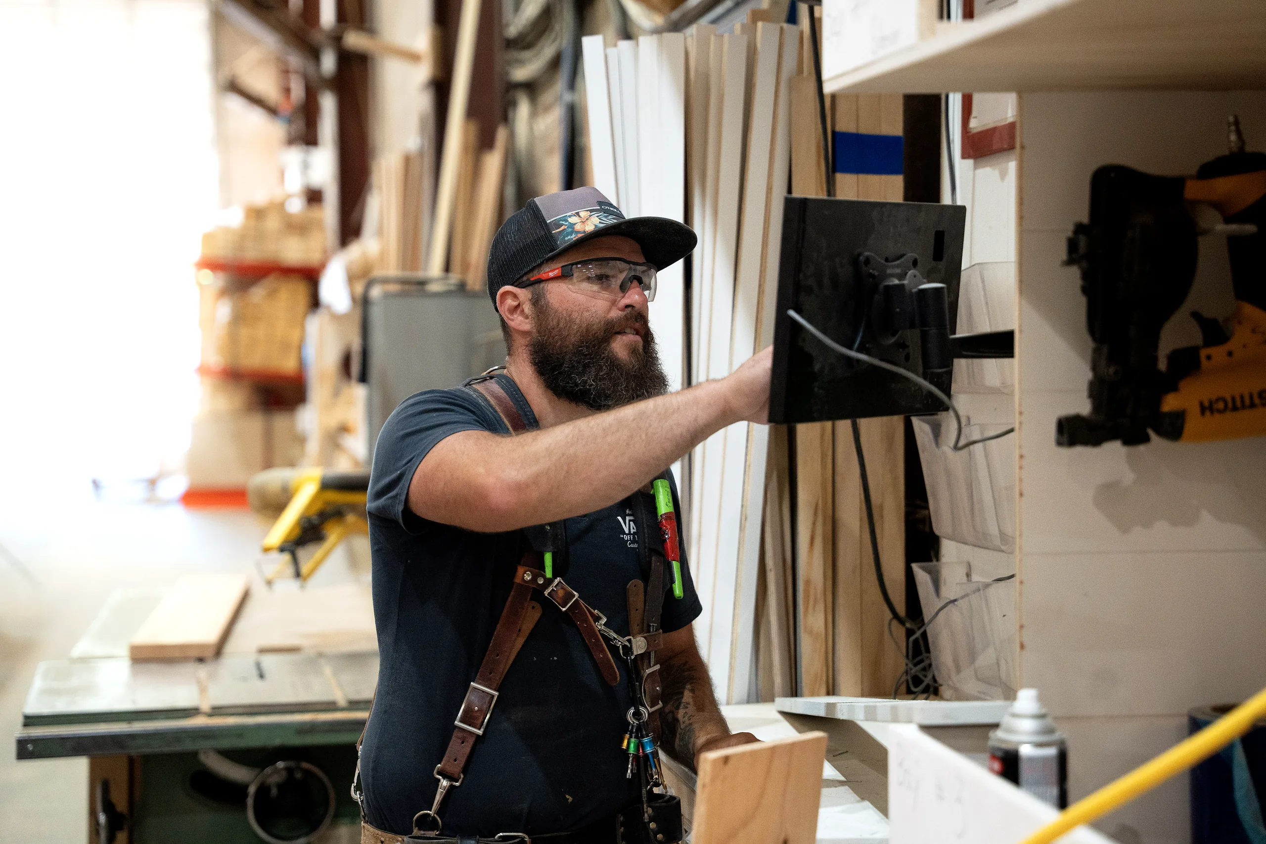 A technician servicing a control panel on the shop floor