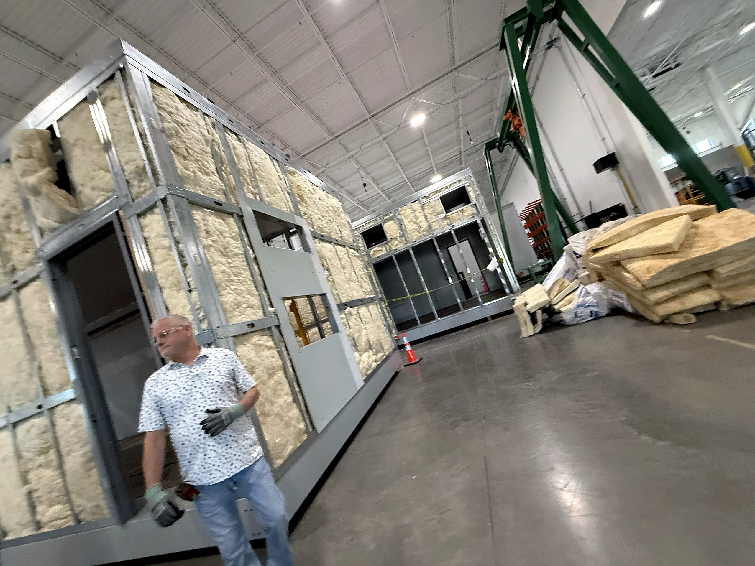A modular electrical room under assembly at EIG, insulated wall panels on a steel frame