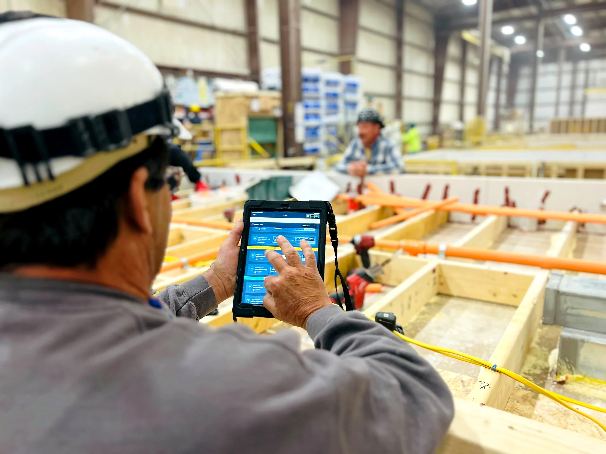 An operator working through a checklist on a shop-floor tablet