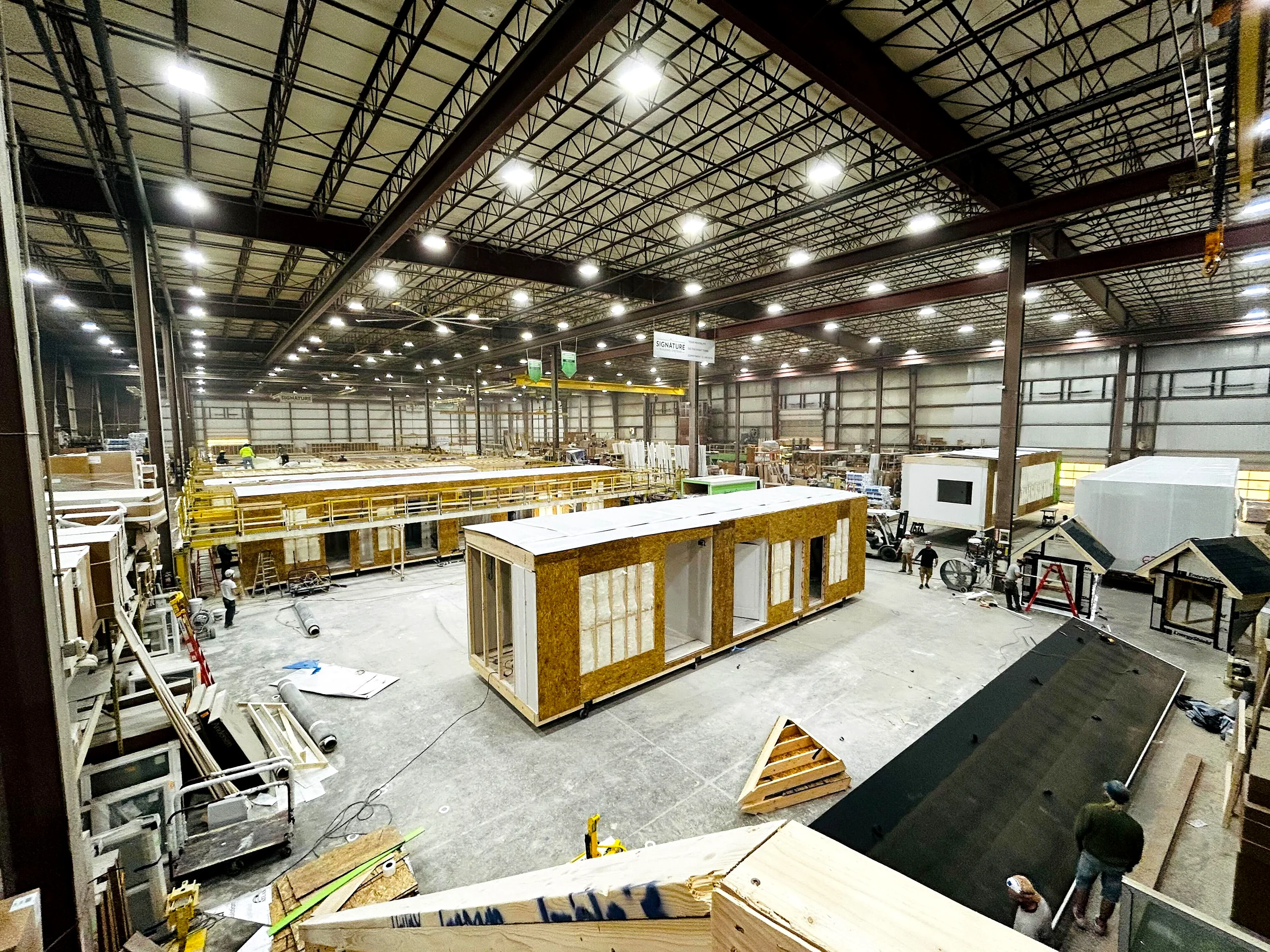 A prefabrication plant floor mid-shift