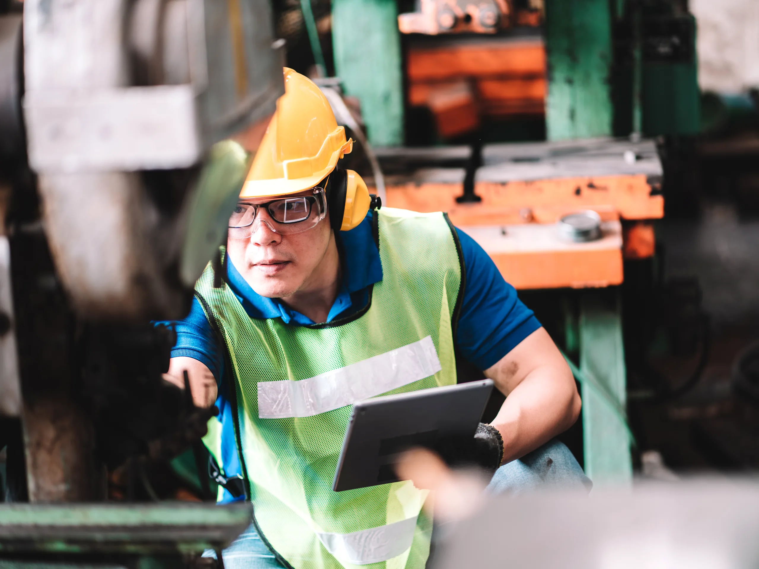A worker running a checklist on a tablet at the line